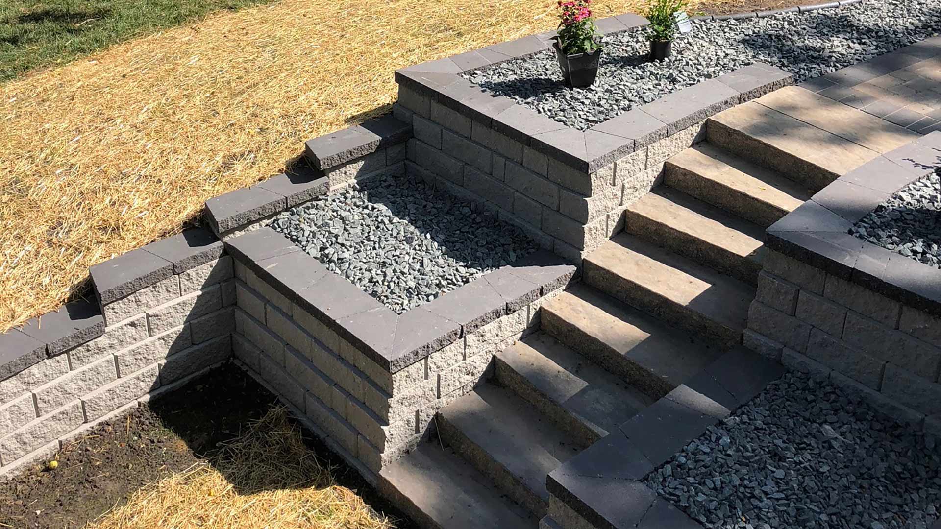 Outdoor steps, retaining walls, and rock installed for client's home in Waukee, IA.