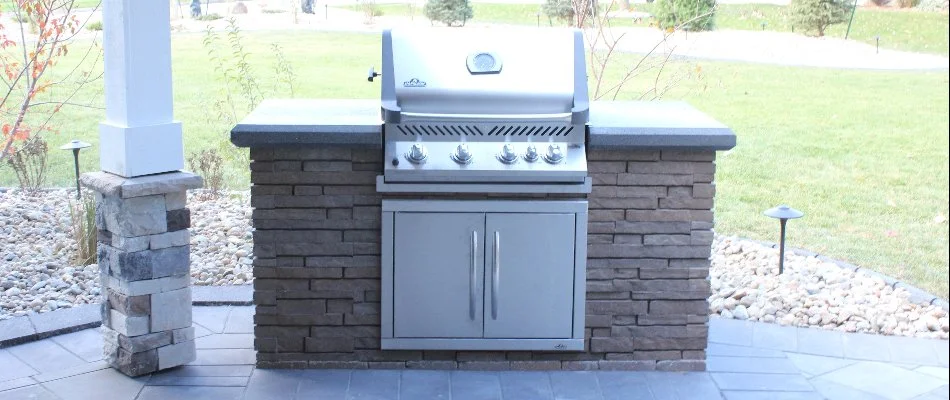 An outdoor kitchen with a grill in Waukee, IA.