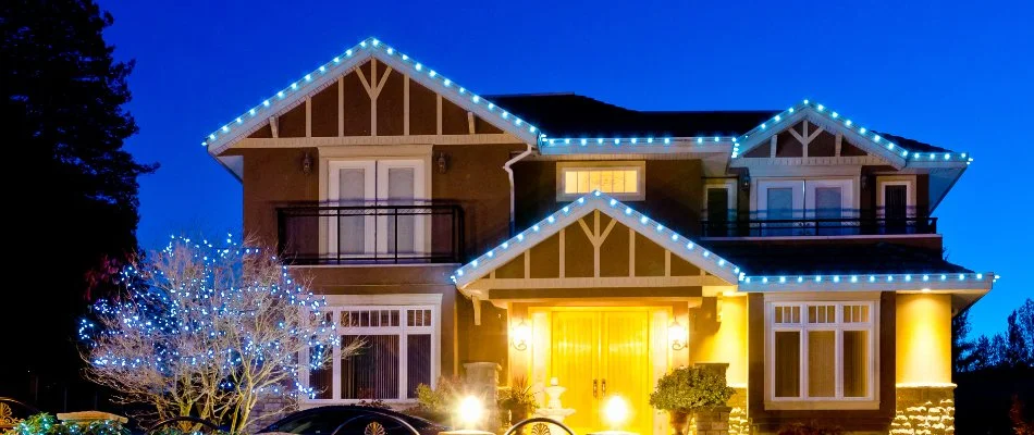 House and tree in Waukee, IA, with cool white holiday lighting.