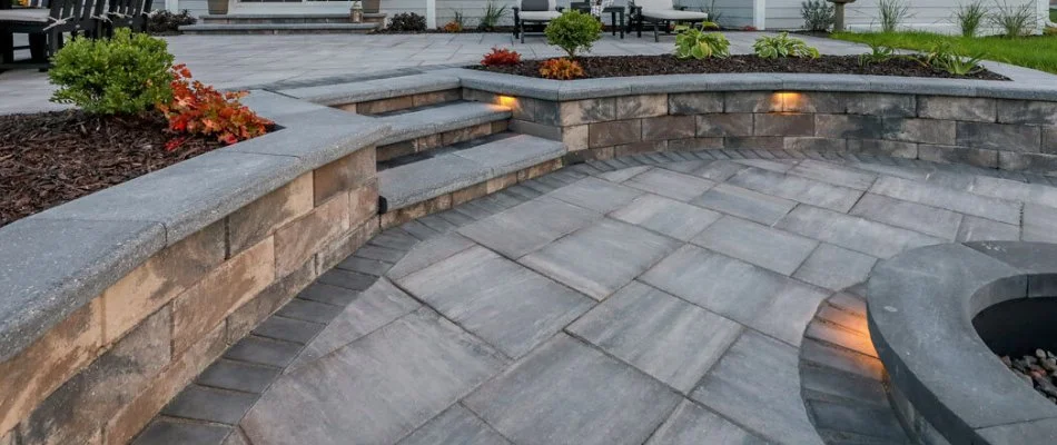 Outdoor space in Waukee, IA, with a paver patio, retaining wall, and outdoor steps.
