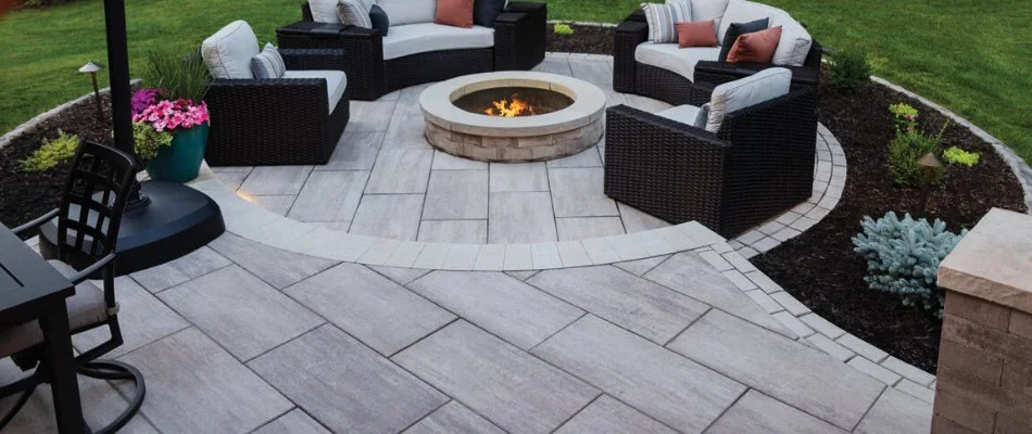 Paver patio in Waukee, IA, with fire pit and chairs.
