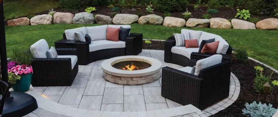 Wood-burning fire pit on a patio in Waukee, IA, with chairs.