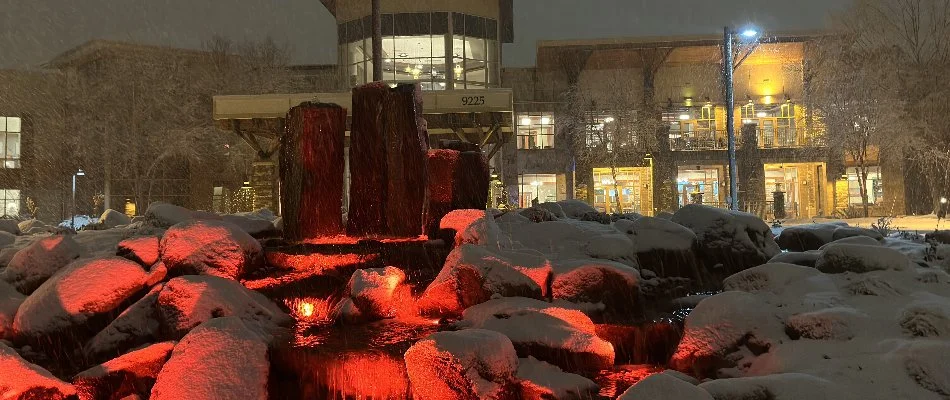 Commercial property in Cumming, IA, with water feature and landscape lighting.