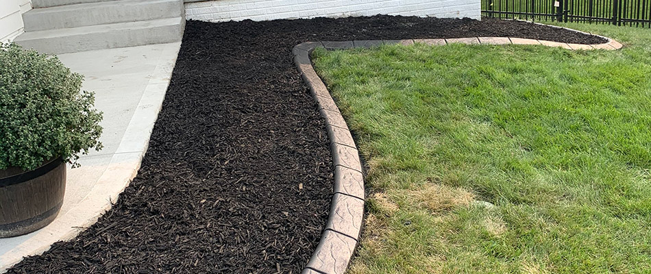 Concrete edging installed by mulch bed near Waukee, IA.