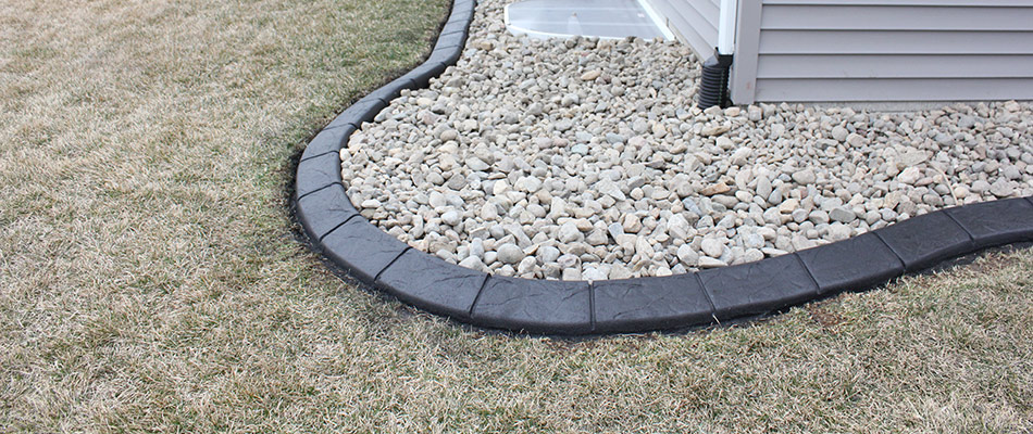 Decorative concrete edging installed for a rock bed in Urbandale, IA.