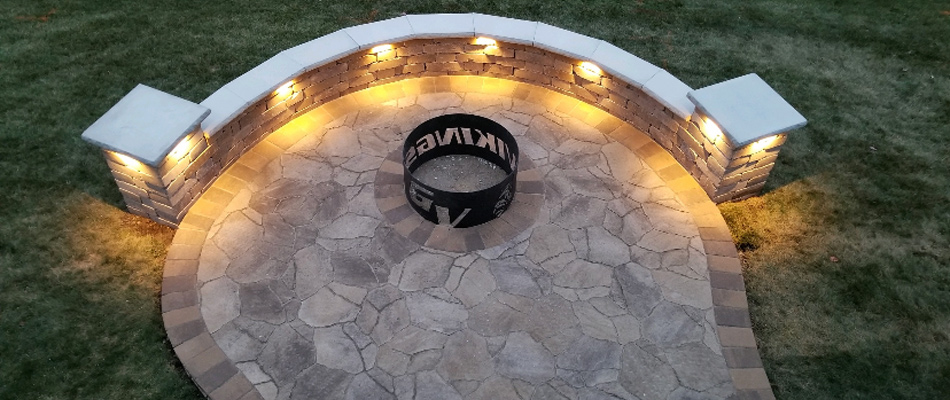 Landscape lighting installed under seating walls in Waukee, IA.