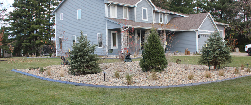 Rock ground covering added to a landscape bed in Johnston, IA.
