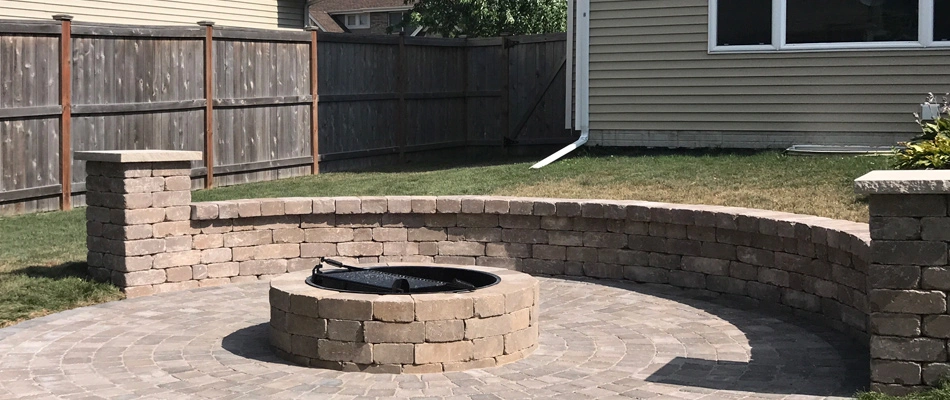 Seating wall installed near fire pit in Grimes, IA.