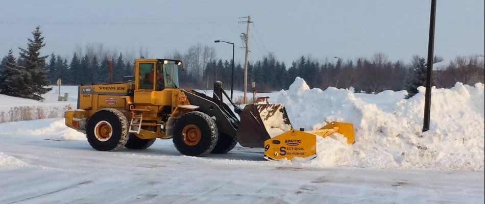 Removing snow in a commercial area in Lovington, IA.