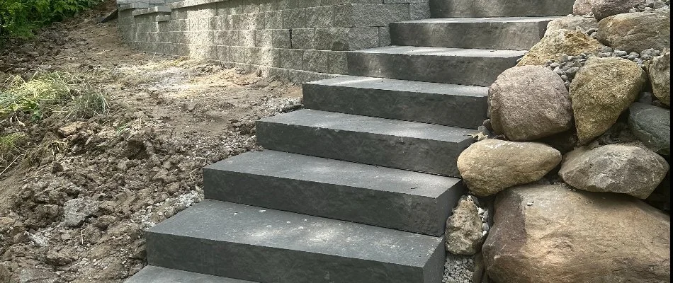 Stone steps leading through a wooded landscape in Waukee, IA.