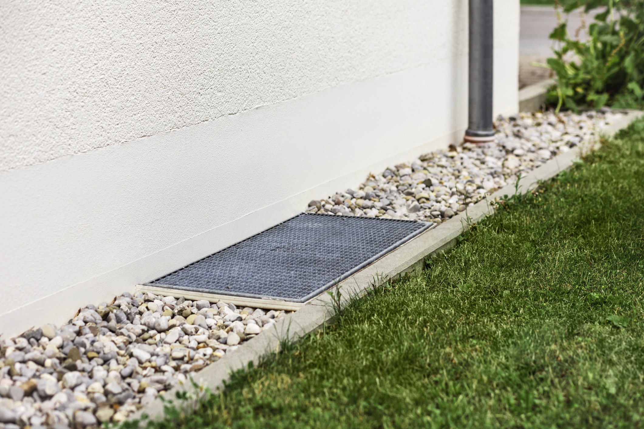 A French Drain Trench with Gravel along a House's exterior Wall.